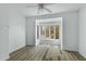Bright, airy bedroom featuring a large bay window and sleek, light-colored laminate flooring at 4955 E Indian School Rd # 5, Phoenix, AZ 85018
