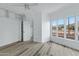 This bedroom has neutral paint, new flooring, great windows, and a ceiling fan at 4955 E Indian School Rd # 5, Phoenix, AZ 85018