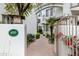 Inviting entrance through gate, leading to charming building with lush landscaping at 4955 E Indian School Rd # 5, Phoenix, AZ 85018