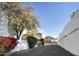 Stylish building exterior with blooming tree, garden, and row of garages at 4955 E Indian School Rd # 5, Phoenix, AZ 85018