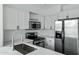 Bright kitchen with stainless steel appliances, white cabinets, and tiled backsplash at 4955 E Indian School Rd # 5, Phoenix, AZ 85018