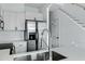 Close-up of a modern sink in a kitchen with stainless steel appliances and white cabinets at 4955 E Indian School Rd # 5, Phoenix, AZ 85018