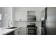 Bright kitchen features stainless steel appliances, white cabinets, and modern fixtures at 4955 E Indian School Rd # 5, Phoenix, AZ 85018
