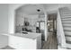 Modern kitchen with stainless steel appliances and sleek white cabinetry, open to stairs at 4955 E Indian School Rd # 5, Phoenix, AZ 85018