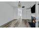 Open-concept living room with a fireplace, wood floors, and modern light fixtures at 4955 E Indian School Rd # 5, Phoenix, AZ 85018