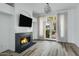 Cozy living room with fireplace, modern light fixture, and doors to the outdoor space at 4955 E Indian School Rd # 5, Phoenix, AZ 85018