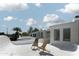 Relaxing rooftop deck featuring modern white architecture and comfortable lounge chairs at 4955 E Indian School Rd # 5, Phoenix, AZ 85018