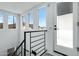 Bright staircase with modern railing, multiple windows with a view, and a doorway to an exterior landing at 4955 E Indian School Rd # 5, Phoenix, AZ 85018