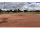 Well maintained community baseball field under a cloudy sky with light poles in the background at 5629 E Thunderbird Rd, Scottsdale, AZ 85254