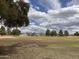 Community baseball field is framed by trees and a cloudy sky with mountain views in the distance at 5629 E Thunderbird Rd, Scottsdale, AZ 85254