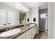 Bathroom with double sinks, granite counters, and shower at 5629 E Thunderbird Rd, Scottsdale, AZ 85254
