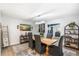 Dining room with a wooden table, stylish chairs, modern lighting, and decorative shelving at 5629 E Thunderbird Rd, Scottsdale, AZ 85254