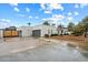 Contemporary home showcasing desert landscaping and gated driveway at 5629 E Thunderbird Rd, Scottsdale, AZ 85254