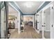 Bright foyer featuring wood flooring, calming wall color, and views into living spaces at 5629 E Thunderbird Rd, Scottsdale, AZ 85254