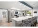 Modern kitchen with white cabinetry, stainless steel appliances, and a breakfast bar with seating at 5629 E Thunderbird Rd, Scottsdale, AZ 85254