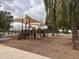 Community playground with sunshades, multiple slides, and climbing equipment on a soft ground cover at 5629 E Thunderbird Rd, Scottsdale, AZ 85254