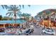 Outdoor shopping plaza with palm trees, pedestrians, and various restaurants under blue skies at 5629 E Thunderbird Rd, Scottsdale, AZ 85254