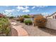Well-maintained backyard with desert landscaping, meandering walkways and fountain at 6200 S Championship Dr, Chandler, AZ 85249
