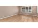 Bright bedroom with wood-look floors and a large window offering ample natural light at 6200 S Championship Dr, Chandler, AZ 85249