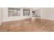Spacious and bright living room featuring light wood floors and large windows with decorative curtains at 6200 S Championship Dr, Chandler, AZ 85249