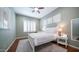 Bright bedroom with a white bed frame, hardwood floors, and natural light from shuttered windows at 6774 S Pinehurst Dr, Gilbert, AZ 85298