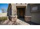 Inviting front entrance featuring stone accents, desert landscaping, and a classic wooden door at 6774 S Pinehurst Dr, Gilbert, AZ 85298