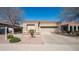 Well-kept single-story house with desert landscaping, two-car garage, and a clear blue sky at 6774 S Pinehurst Dr, Gilbert, AZ 85298