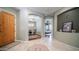 Inviting hallway with arched doorways leading to office and bedroom, and decorative tiled floors at 6774 S Pinehurst Dr, Gilbert, AZ 85298