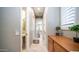 Inviting hallway with neutral walls leads to a bathroom and bedroom featuring great natural light from the windows at 6774 S Pinehurst Dr, Gilbert, AZ 85298