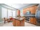 Well-lit kitchen featuring stainless steel appliances, granite countertops and an island with breakfast bar at 6774 S Pinehurst Dr, Gilbert, AZ 85298