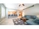 Open-concept living room with bar seating looking into the kitchen, and comfortable blue sofa at 6774 S Pinehurst Dr, Gilbert, AZ 85298