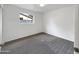 Bright, carpeted bedroom with a window offering natural light, perfect for creating a comfortable retreat at 709 S Toltec --, Mesa, AZ 85204