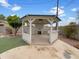 Backyard gazebo with a fireplace, bar, and ceiling fan at 709 S Toltec --, Mesa, AZ 85204