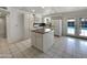 Spacious kitchen with white cabinets, an island, and a view of the outdoor pool through French doors at 709 S Toltec --, Mesa, AZ 85204