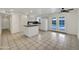 Bright kitchen with white cabinets, an island, and view of the outdoor pool through French doors at 709 S Toltec --, Mesa, AZ 85204