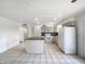 Bright kitchen with white cabinets, an island, and modern appliances providing ample space for cooking at 709 S Toltec --, Mesa, AZ 85204