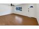 Bright and open living space with hardwood floors, a ceiling fan, and a large front window at 709 S Toltec --, Mesa, AZ 85204