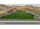 Aerial view of a park that's being watered in the Noravita community at 7414 W Whitehorn Trl, Peoria, AZ 85383