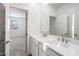 Modern bathroom featuring double sinks, sleek countertops, and contemporary fixtures at 7414 W Whitehorn Trl, Peoria, AZ 85383