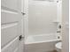 Bathroom features a white bathtub, shower combo, and a toilet at 7414 W Whitehorn Trl, Peoria, AZ 85383