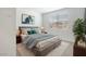 Bright bedroom featuring a comfortable bed, stylish decor, and a large window at 7414 W Whitehorn Trl, Peoria, AZ 85383