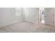 Bedroom with plush carpet, closet with sliding doors, and bright window at 7414 W Whitehorn Trl, Peoria, AZ 85383