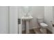 Modern powder room features a pedestal sink, toilet, and contemporary fixtures at 7414 W Whitehorn Trl, Peoria, AZ 85383