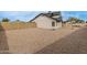 Side view of gravel backyard with privacy fence at 7637 W North Ln, Peoria, AZ 85345