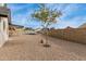 Spacious backyard featuring a pool with secure fencing and low-maintenance desert landscaping at 7637 W North Ln, Peoria, AZ 85345