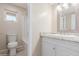Bathroom featuring a white single sink vanity, white walls, shower over tub, and toilet at 7637 W North Ln, Peoria, AZ 85345