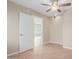 An empty room has a neutral wall color and tile floor, with access to another room at 7637 W North Ln, Peoria, AZ 85345