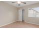 Bedroom featuring a ceiling fan, neutral wall color, closet, and window for natural light at 7637 W North Ln, Peoria, AZ 85345