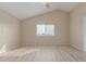 Bedroom with vaulted ceiling, large window with blinds, and wood laminate floors at 7637 W North Ln, Peoria, AZ 85345