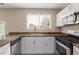 Well-equipped kitchen with stainless steel appliances, white cabinets, and convenient counter space at 7637 W North Ln, Peoria, AZ 85345